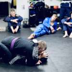 Our members listening to Sid teaching a BJJ technique