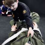 Two kids working on a bjj technique